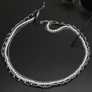 Detail of multi-layer eyewear chain with pearls, leather-metal link, and non-slip loops