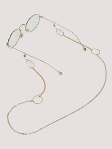 Detail of golden glasses chain with geometric rings and white rubber loop connectors