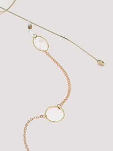 Close-up of golden geometric circle eyeglass chain with non-slip silicone connectors