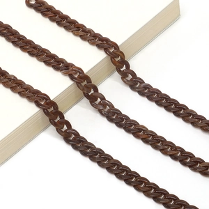 Macro detail of acrylic eyewear chain with brown translucent amber leopard print links