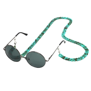 Close-up of green tortoise shell acrylic eyeglass chain with round metal sunglasses