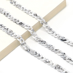 Black and white acrylic marble pattern eyeglass chain with oval links on a white desk
