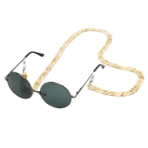 Close-up of retro black round sunglasses with chunky beige acrylic oversized chain link