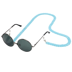 Detail showing blue acrylic eyeglass chain with silver lobster clasps on round sunglasses