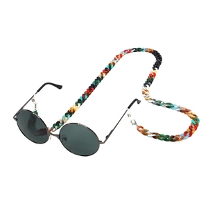 Macro shot of colorful chunky acrylic chain links with metal round frame sunglasses