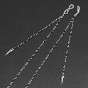 Detailed view of silver metal eyewear chain with rivet pendants and rhinestone accents