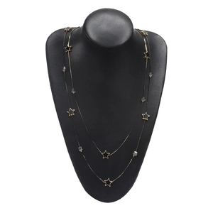Dual-layer gold chain necklace with black star charms and clear beads on neck model