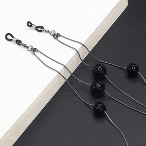 Detail of silver snake chain eyewear strap with black beads and rubber loops