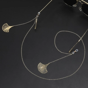 Golden metal eyewear chain featuring gingko leaf pendants and non-slip silicone loops