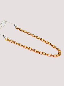 Detail of leopard resin eyeglass chain with tortoiseshell links and adjustable loops