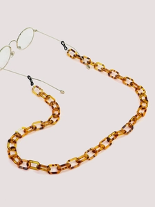 Detail of leopard print acrylic eyewear chain with non-slip rubber loops on gold frames