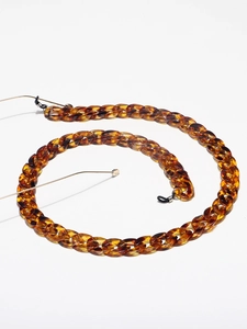 Detailed view of leopard print resin chain links with black silicone eyeglass connectors