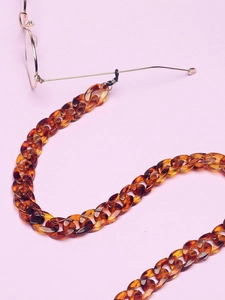 Detailed view of amber leopard pattern acrylic link eyeglass chain with rubber connectors