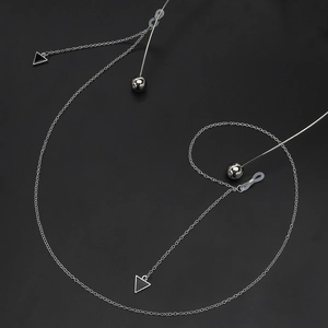 Silver metal eyewear chain with black triangle charms and non-slip silicone connectors