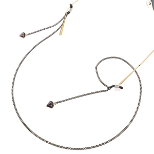 Fashionable black metal eyewear chain featuring geometric diamond-shaped pendants and gold accents
