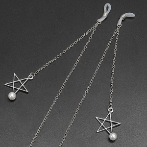 Silver anti-slip metal eyewear chain with star pendants and pearls on grey surface