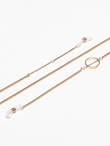 Detail of golden box chain eyewear strap with non-slip silicone loops and metal rings