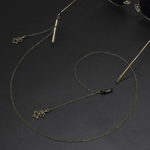 Bronze punk eyewear chain featuring skull charms and anti-slip silicone loops for glasses