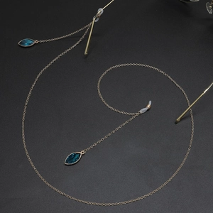 Golden metal eyewear chain featuring elegant blue cat-eye pendants and silicone loops