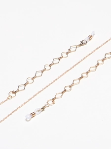 Detail of golden metal glasses chain with geometric links and silicone loops