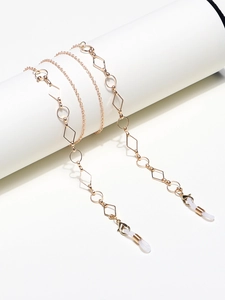 Detail of golden geometric eyewear chain with silicone loops and lobster clasps