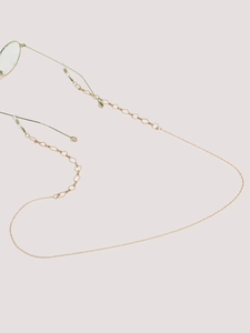Detail of gold geometric eyewear chain with non-slip silicone loops and metal rings