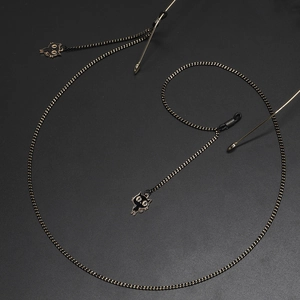 Fashionable black and gold eyewear chain featuring cute enamel cat charms with metal loops