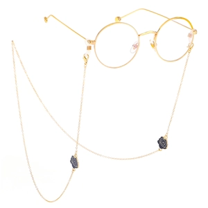 Golden eyewear chain with black rose charms on round metal glasses and anti-slip loops