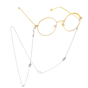 Silver metal eyewear chain with turtle charms on round gold frame glasses