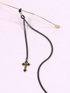 Detail of black glasses chain with a black and gold cross pendant and silicone loops