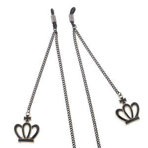 Golden eyewear chain with black crown pendant and cross detail on a white backdrop
