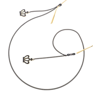 Elegant black metal eyewear chain with golden crown cross charms on white backdrop