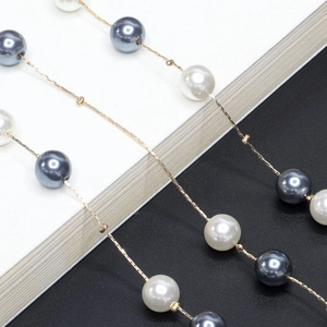Elegant gold chain necklace featuring grey and white pearls in a dual-purpose design