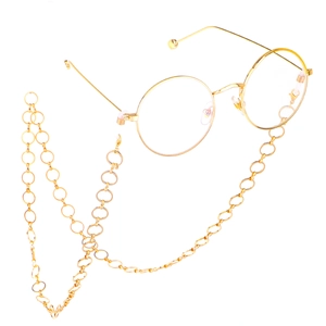 Golden round frame glasses with matching metal circular link chain on white background