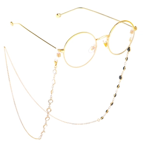 Golden round frame glasses with handmade black and white beaded chain on white background