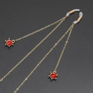 Gold anti-slip eyewear chain featuring red rhinestone crown pendants and silicone loops