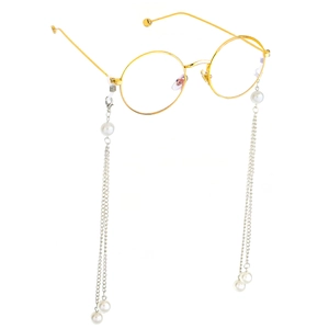 Golden round glasses with vintage pearl chain strap accessory on white background