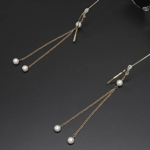 Elegant gold pearl eyeglasses chain with silicone loops for women on dark background
