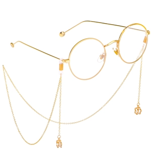 Gold round metal glasses with non-slip floral zircon chain pendant on white background