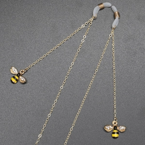 Golden metal eyewear chain with rhinestone bee charms and non-slip rubber loops