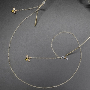 Golden anti-slip eyewear chain featuring crystal bee pendants with rhinestone details