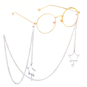 Detail of silver metal glasses chain with hollow star pendant on round gold frame