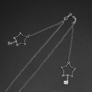 Silver metal eyewear chain with hollow stars and key charms on a black background