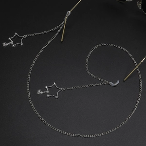Silver metal eyewear chain with star charms and non-slip silicone loops on black background