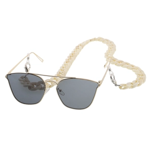 Detail of gold metal aviator sunglasses with cream acrylic twist link chain strap