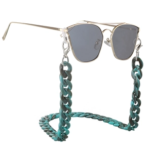 Blue marble acrylic glasses chain with gold metal sunglasses on a white background