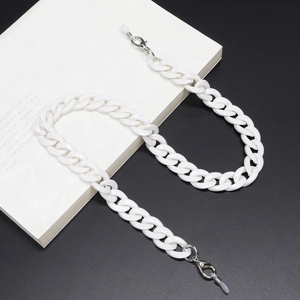 Detail of white chunky acrylic resin chain links with silver lobster clasps and rubber loops