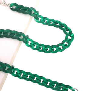 Macro shot of dark green acrylic link chain with glossy finish and silver metal clasps