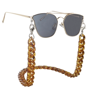 Close-up of thick amber acrylic eyewear chain with metallic aviator sunglasses