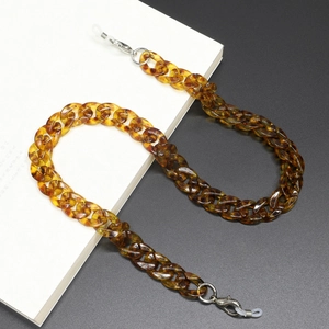 Detail of amber tortoiseshell acrylic glasses chain with white non-slip rubber loops